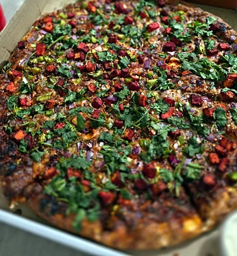 Pizza topped with fresh cilantro