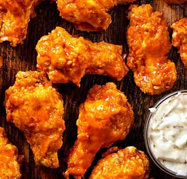 Close view of sauced chicken wings