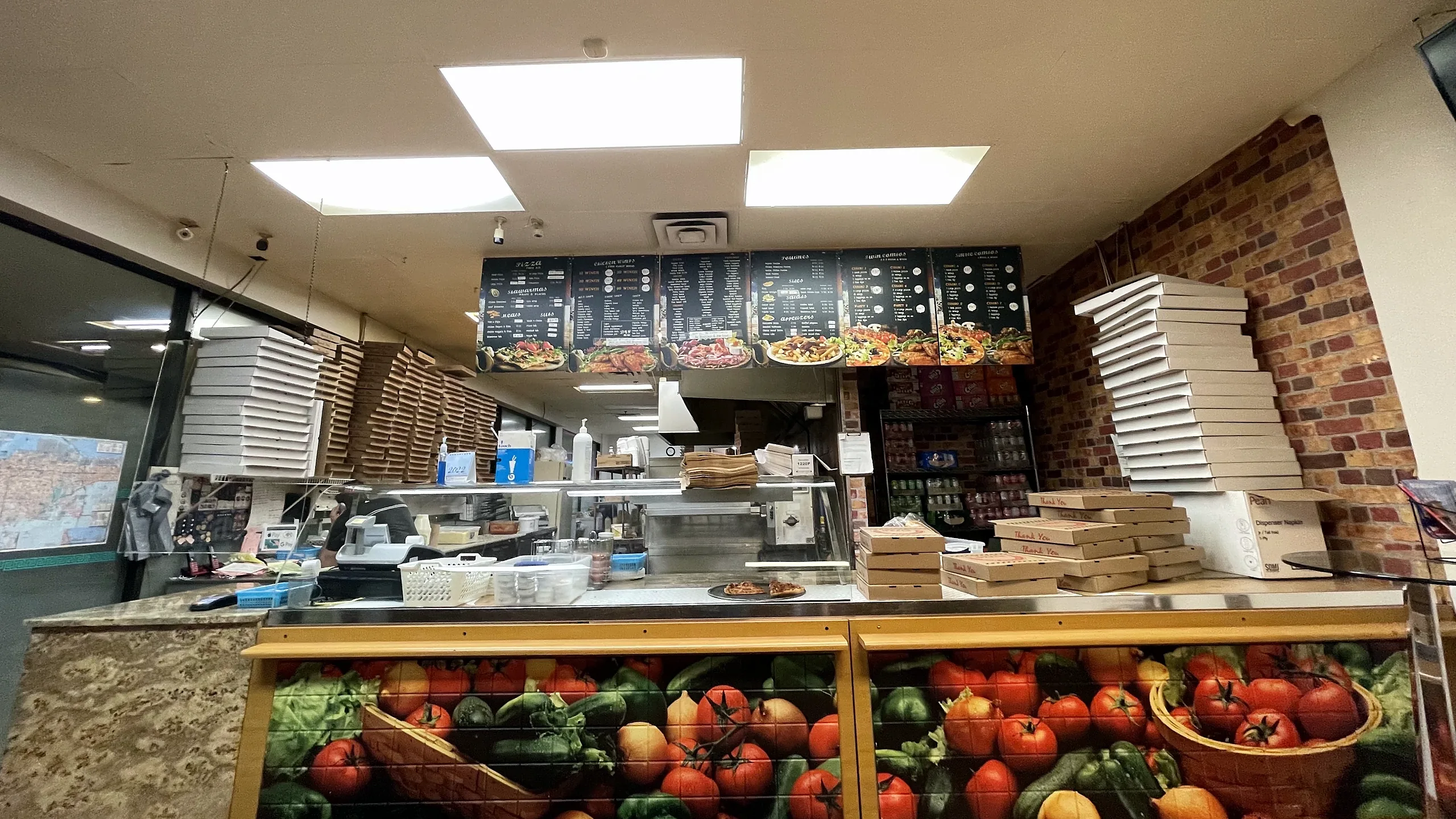 Lava Pizza & Wings counter at 550 Fennell Ave E with menu boards and pizza boxes